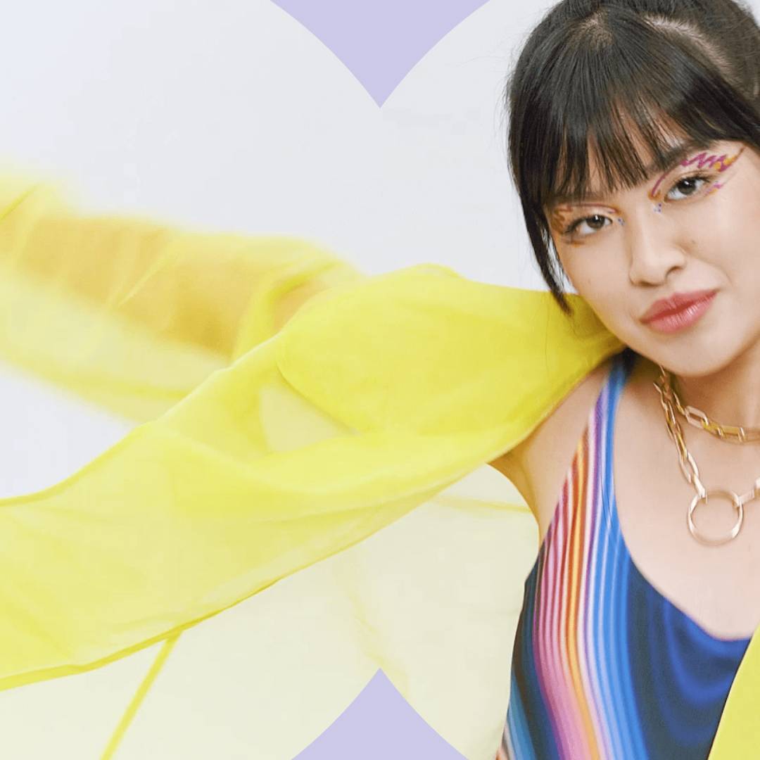 Fashion model with colorful makeup and vibrant styling featured in a beauty campaign photoshoot.