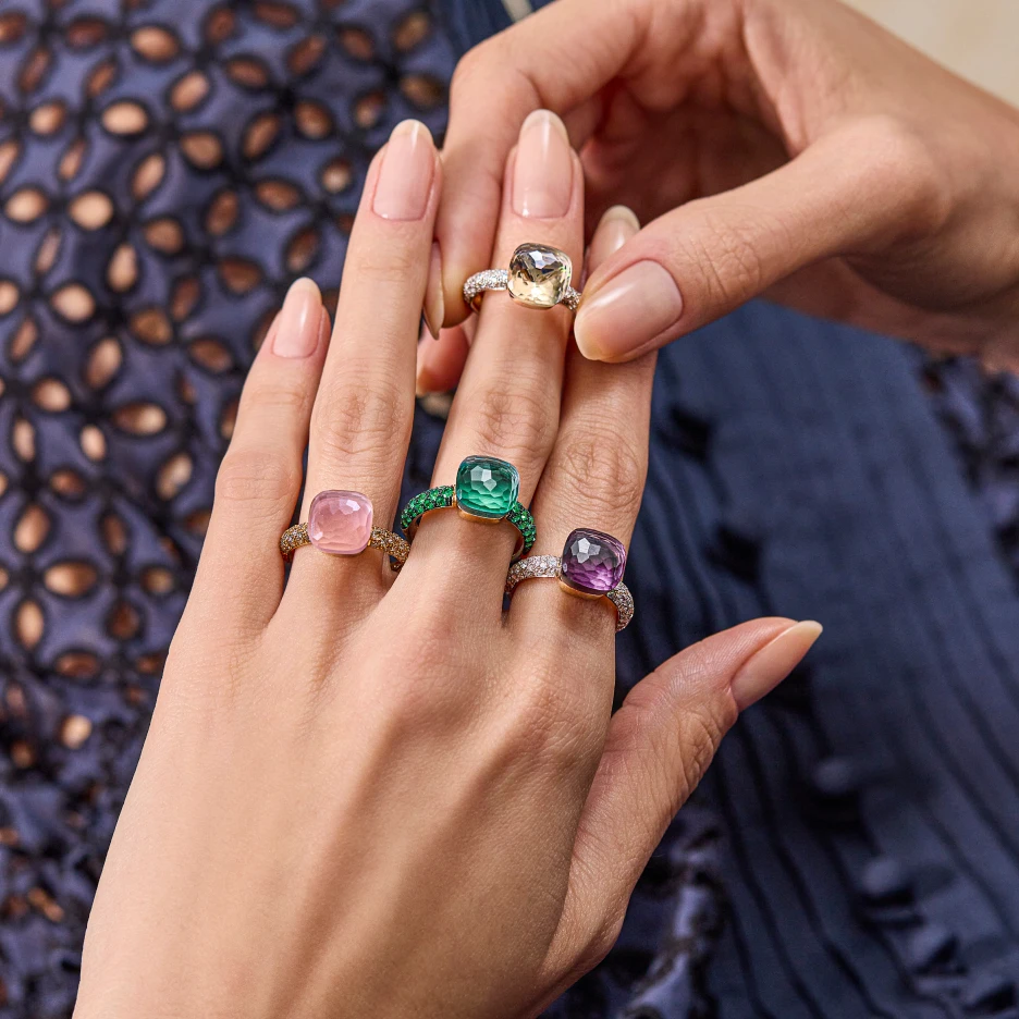 Close-up of hands wearing colourful gemstone rings showcasing detailed jewellery photography with professional photo retouching