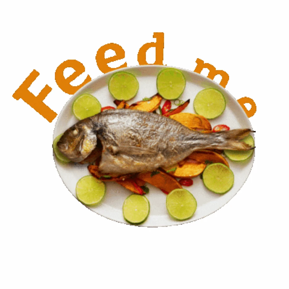 Plate of whole cooked fish served with lime slices and roasted vegetables, presented as a food dish.