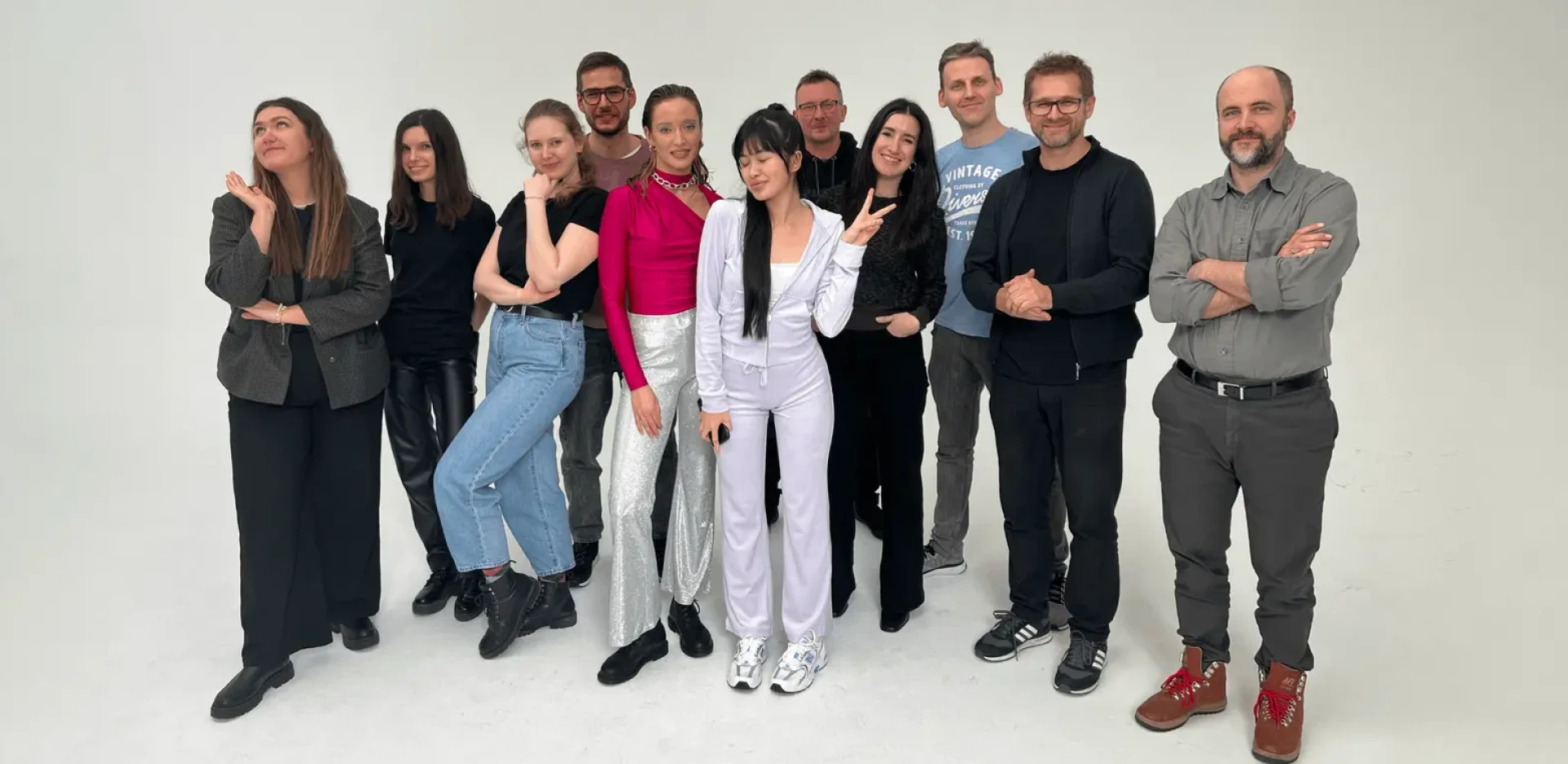 Creative production team standing together in a professional photography studio during a commercial shoot