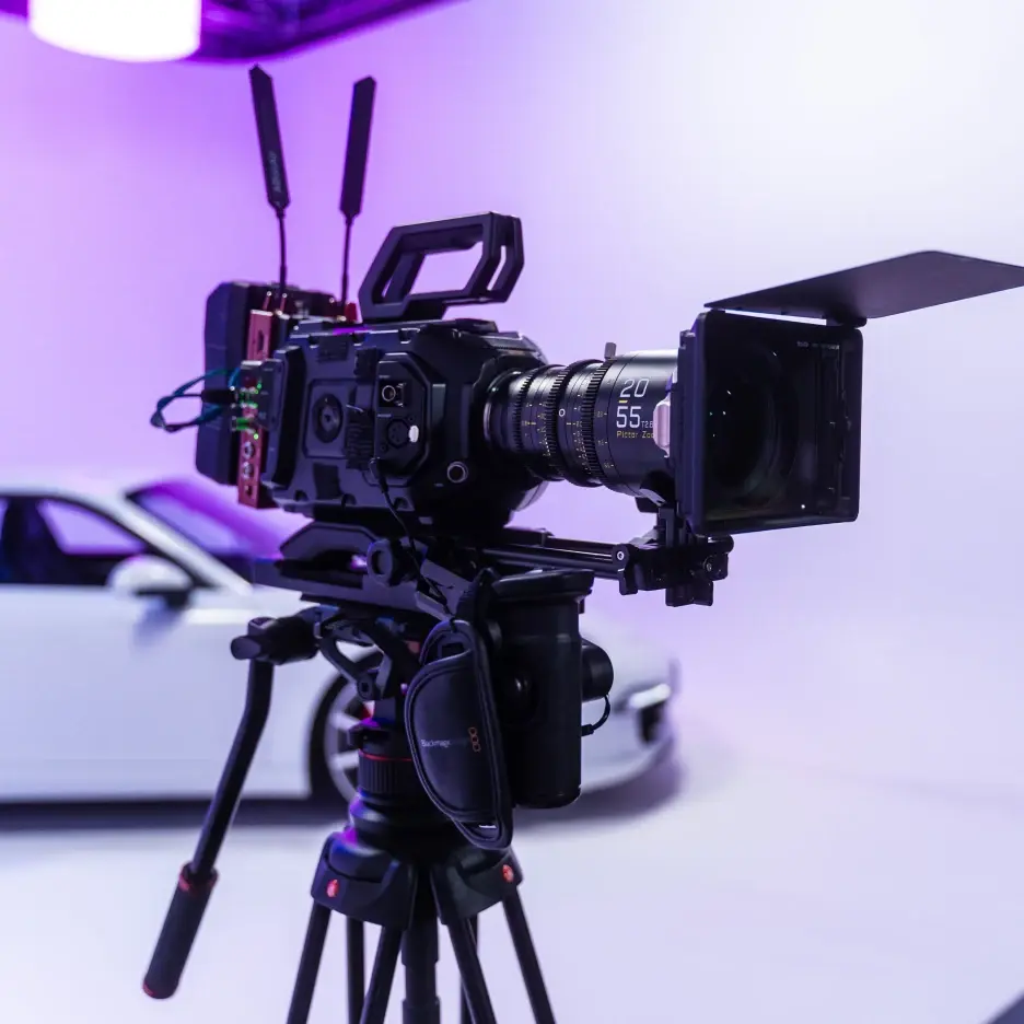 Professional cinema camera on tripod with lens and matte box set up in a studio environment for commercial filming
