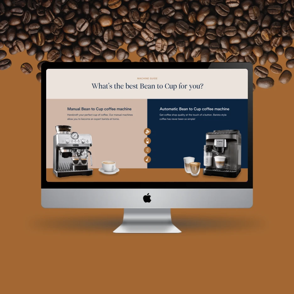 Desktop computer displaying a comparison guide for manual and automatic bean-to-cup coffee machines, with coffee beans scattered above the screen.