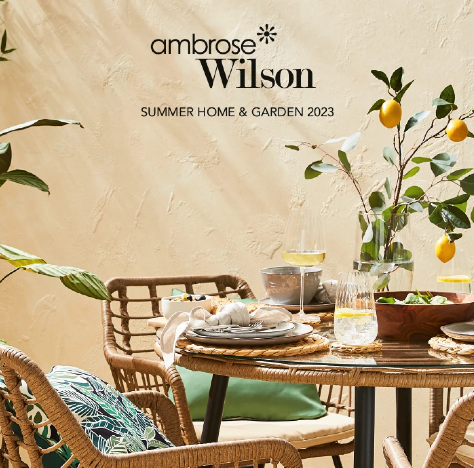 Lifestyle home and garden catalogue cover featuring styled outdoor dining table with lemons and glassware